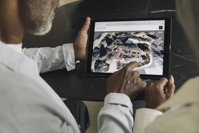 Person reviewing an aerial property view on a tablet